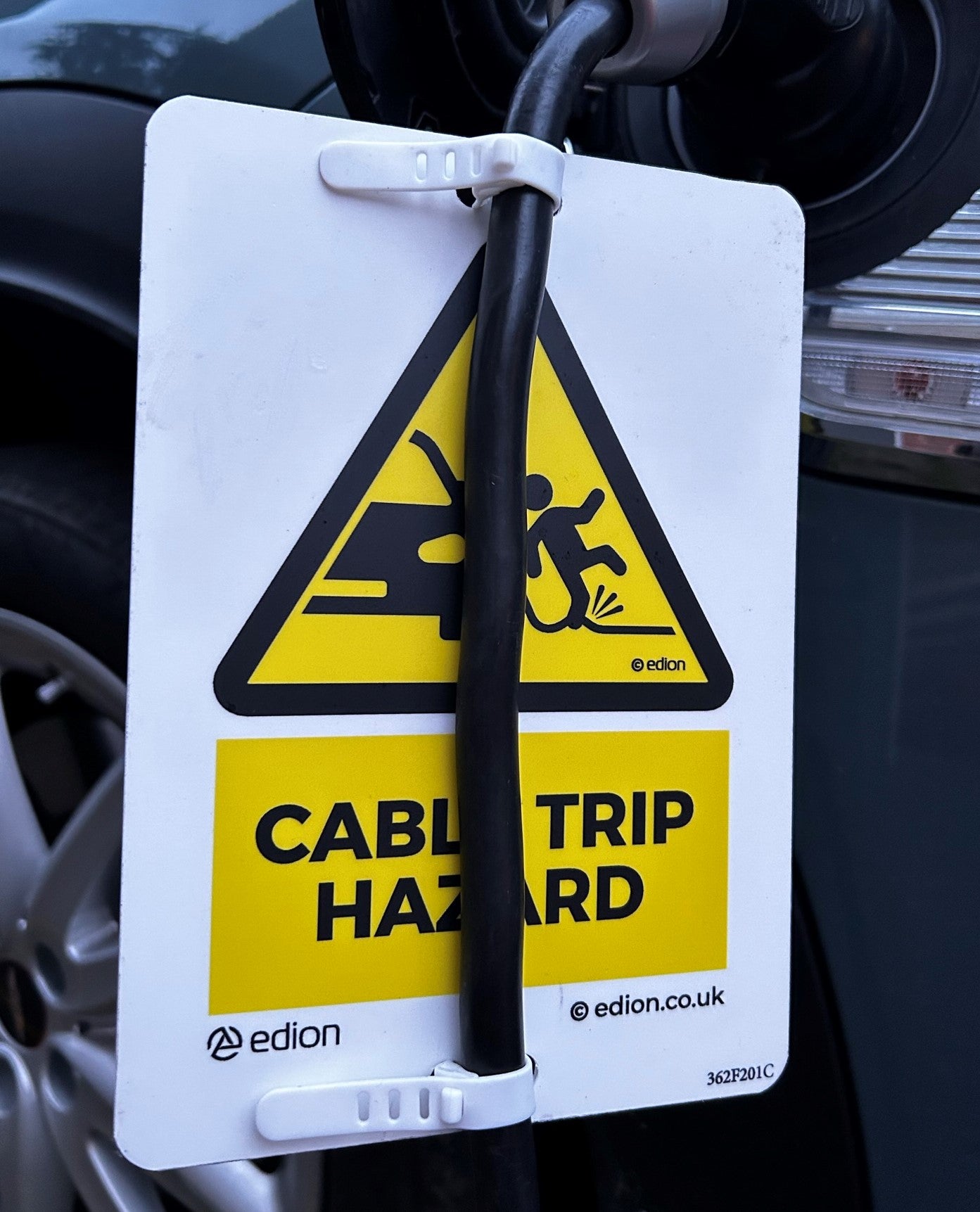 Edion warning sign attached to EV cable